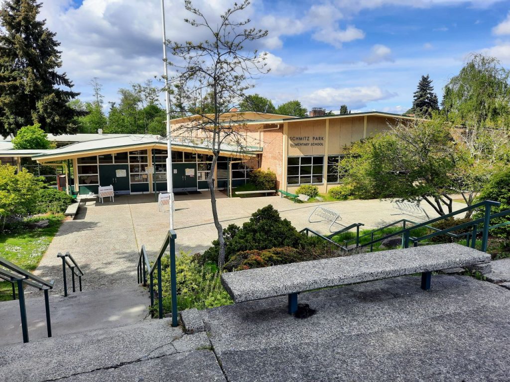 The entrance to Schmitz Elementary School in West Seattle. A bench is in foreground.
