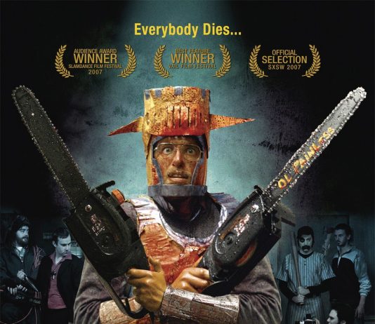 Murder Party Is an Urbanist Halloween Masterpiece Movie poster for Murder Party showing a man in glasses wearing knights armor costume made of cardboard and blood-soaked. He's holding two chainsaws across his chest and looks terrified. An assortment of people are behind him wearing costumes for a baseball player, vampire, robot, and cheerleader.