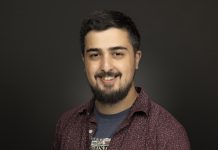 Urbanist Leader Rian Watt Talks Housing Crisis on Hacks & Wonks Podcast Photo of Rian Watt wearing a t-shirt from the National Civil Rights museum and an unbuttoned button down shirt. He is smiling slightly.