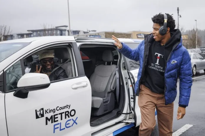 A passenger exits a Metro Flex van and waves to the driver.