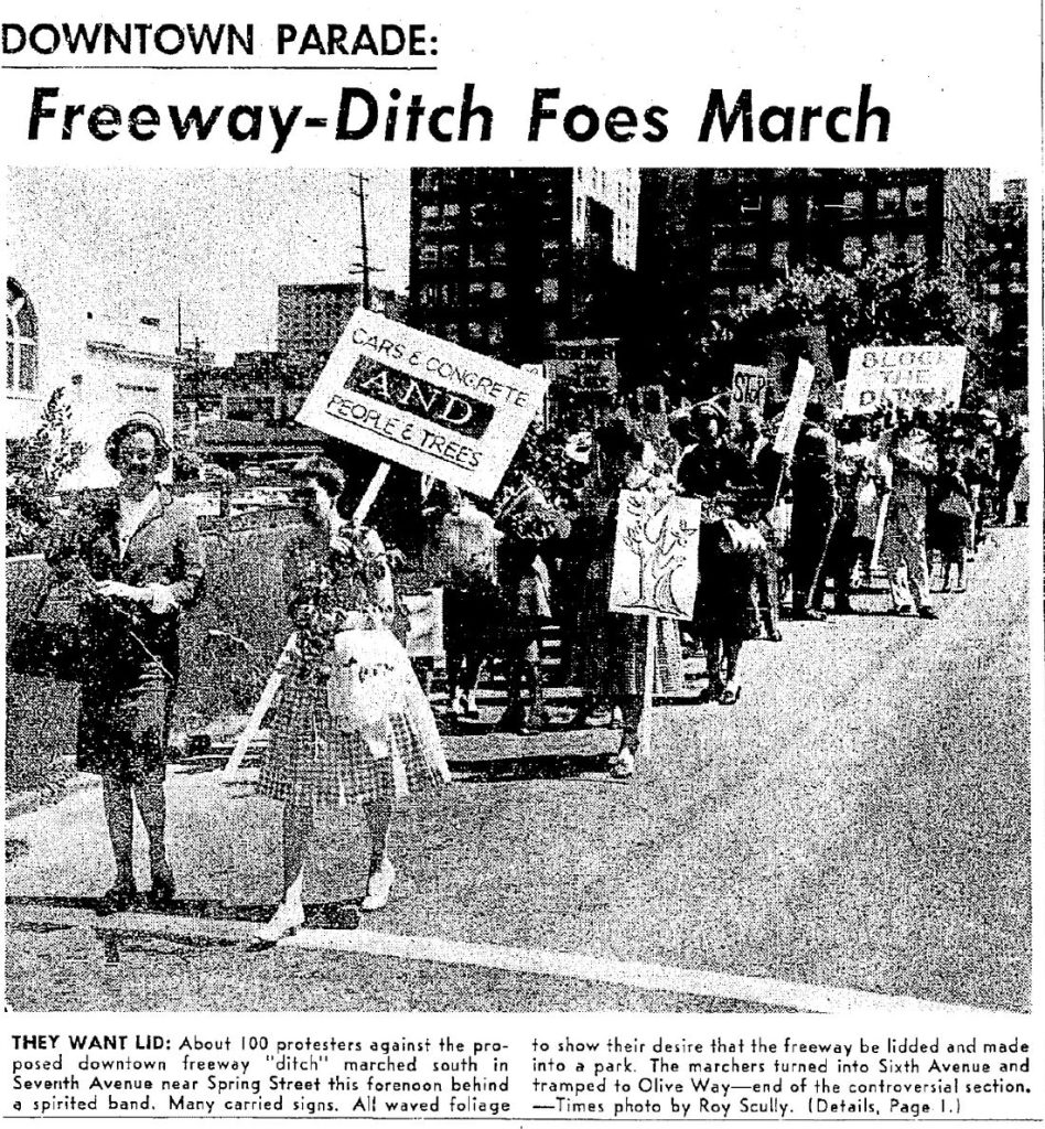 The headline reads "Downtown parade: Freeway-Ditch Foes March" Women smile and brandish signs int he photo with slogans like "Cars & Concrete AND people & trees" and "Block The Ditch"