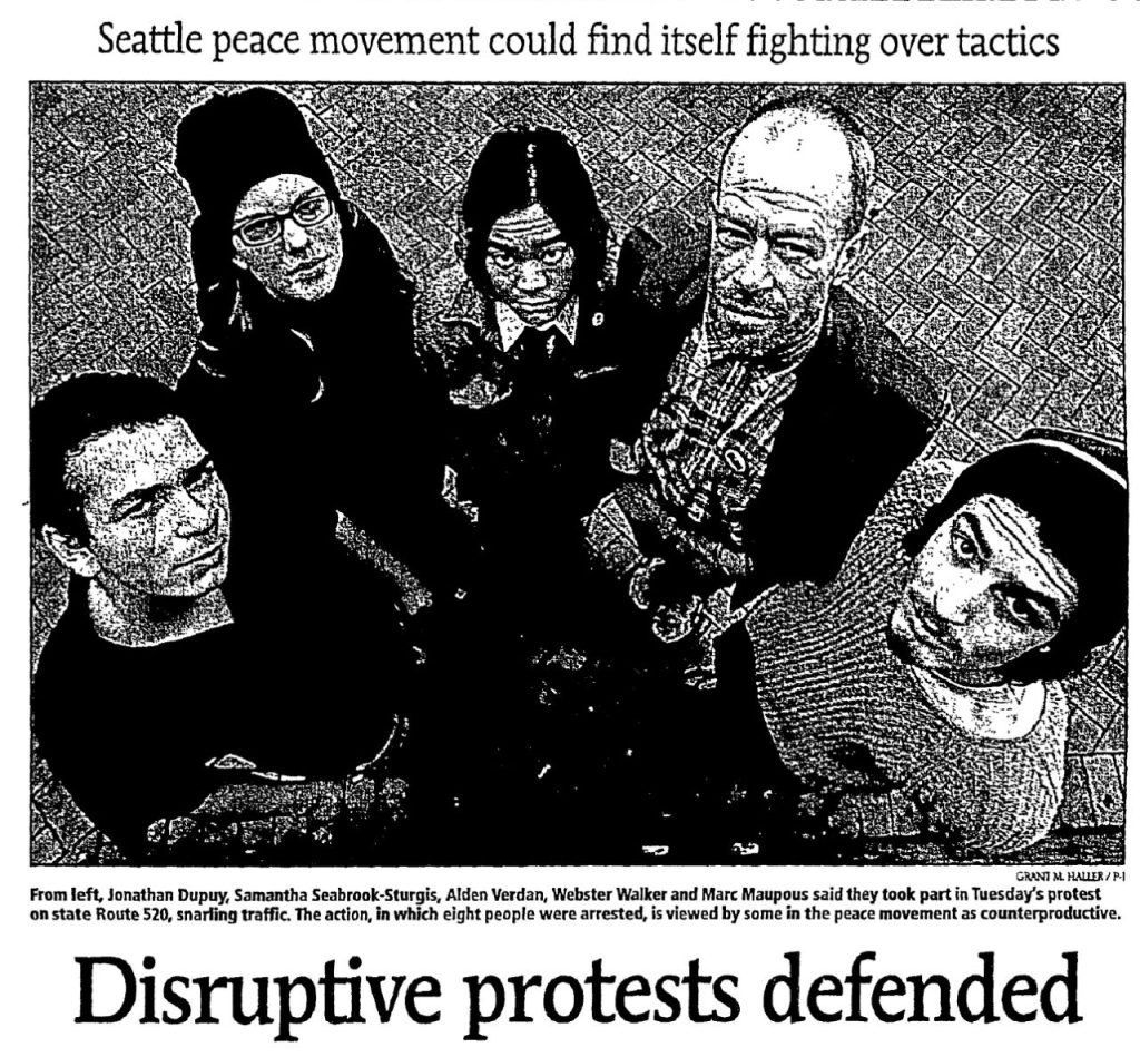 The headline reads Disruptive protests defended, and a subhead reads "Seattle peace movement could find itself fighting over tactics." A caption notes the five people pictured int the photo, Jonathan Dupoy, Samantha Seabrook-Sturgis, Alden Verdan, Webster Walker, and Marc Maupous, said they took part in Tuesday's protest that "snarled traffic." The caption notes "The action, in which eight people were arrested, is viewed by some in the peace movement as counterproductive."