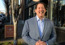 Seattle Risks Missing 2024 Comprehensive Plan Deadline with Continued Delays Mayor Harrell smiles in a gray suit outside a brick storefront.