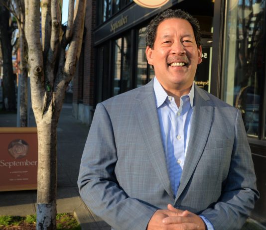 Seattle Risks Missing 2024 Comprehensive Plan Deadline with Continued Delays Mayor Harrell smiles in a gray suit outside a brick storefront.
