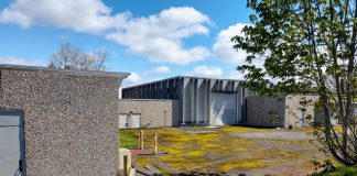 Fort Lawton include patchy grass and drab concrete low slung buildings and garages that used to serve the military installation.