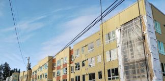 A large four-story apartment building under construction.