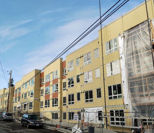 ‘Housing Accountability Act’ Seeks to Push Local Governments to Boost Homebuilding A large four-story apartment building under construction.