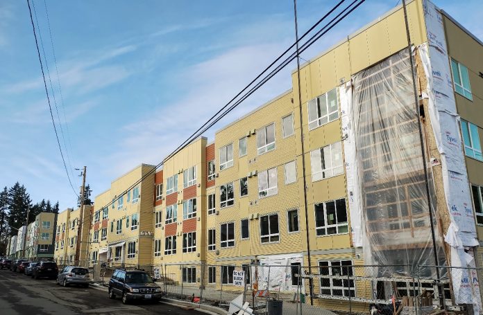 A large four-story apartment building under construction.