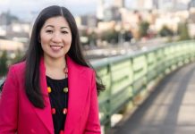 Seattle Council Appoints Morales Challenger Tanya Woo to Fill-In Council Seat Woo poses on the Jose Rizal Bridge with the iconic green railing and Seattle skyline in the background.