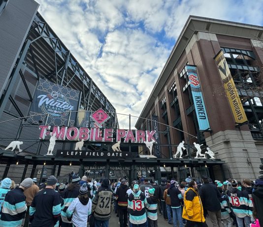 The NHL Winter Classic Can Accelerate Seattle’s Sonics Boom Entrance gate to T-Mobile Park with crowd going through ticketing, looking upward towards soft clouds and banners for Vegas and Seattle.