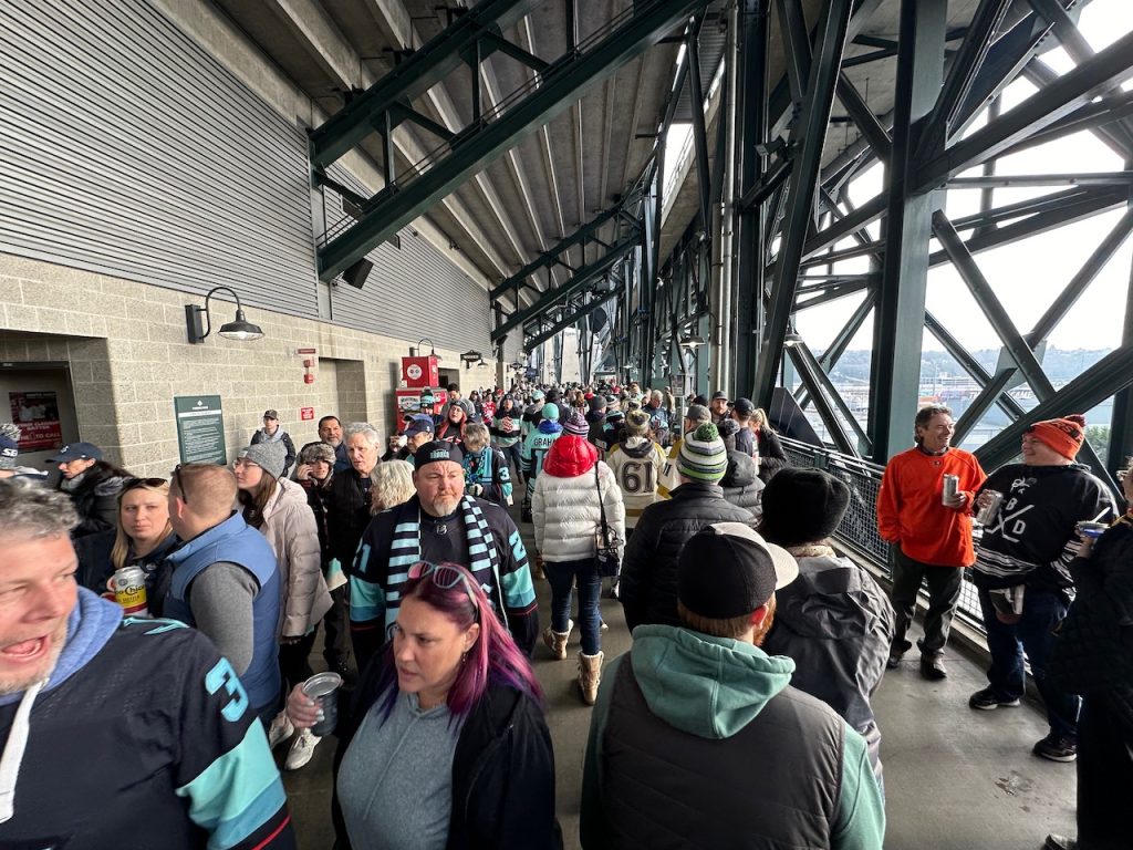 Concession level of the ballpark with thick crowds in thicker winter gear.