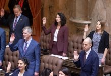 Rent Stabilization Backers Aim to Beat Deadline to Keep Bill Alive State representatives stand at their desks and raise their right hand to take an oath to start the 2023 session.