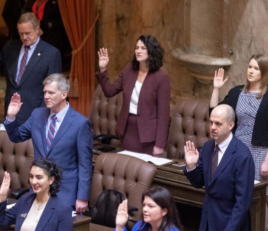 Rent Stabilization Backers Aim to Beat Deadline to Keep Bill Alive State representatives stand at their desks and raise their right hand to take an oath to start the 2023 session.