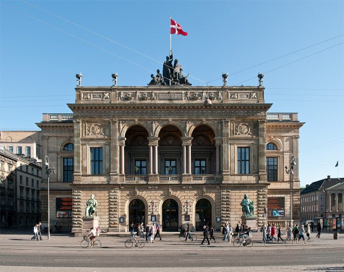 Two greenish copper statues frank the entrance to the theater, which flies a Danish flag at its apex.