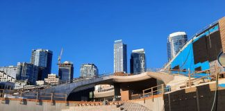 Steps are taking shape even with the concrete not yet poured. The Seattle skyline peeks in the background.