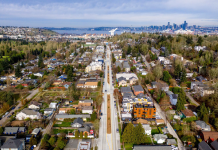 Planners Proposed Bigger Upzones Before Harrell’s Team Intervened, Records Show An aerial photo of a boulevard with port cranes and Elliott Bay in the distance.