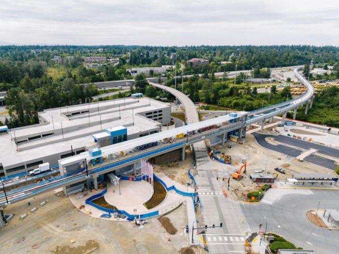 8-16-2023-Lynnwood-Tour-18-bigger A bird's eye view of an elevated station and parking garage.