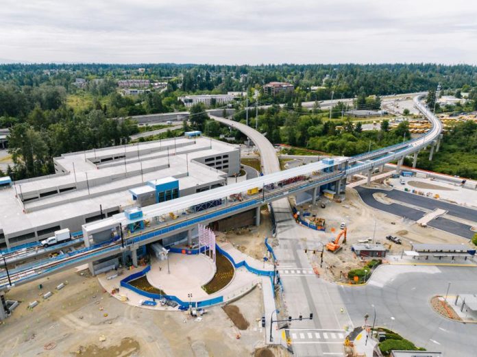 A bird's eye view of an elevated station and parking garage.