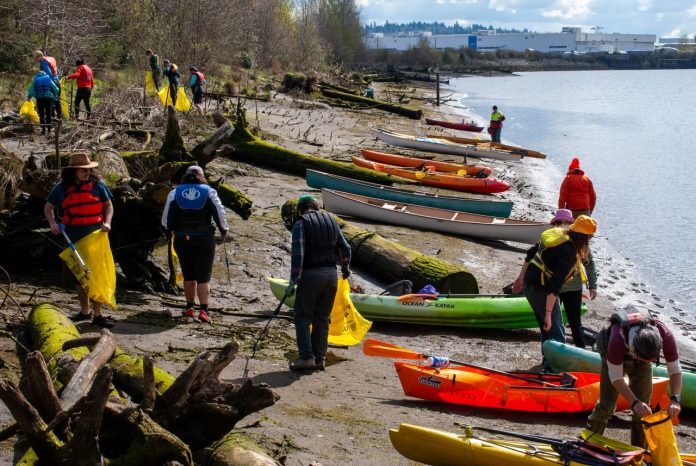 Kayaks beached among the driftwood along the Duwamish River