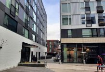 How King County’s Basic Income Program Could Fight Poverty and Increase Safety The courtyard at Midtown Square is surrounded by a 7-story apartment complex.