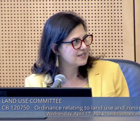 Seattle Land Use Committee Rejects Morales’ Equitable Development Bill Morales wears a yellow blazer and glasses.