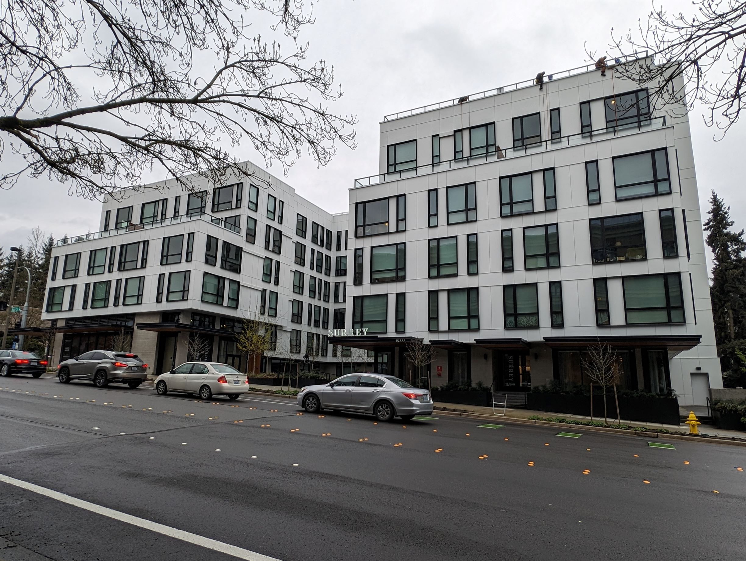 A white five-story building with an upper-level setback.