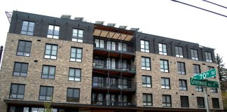 Phinney Ridge Apartment Complex Pioneers Unique Communal Model A bike whizzes by on Greenwood Avenue with a brick building in the background
