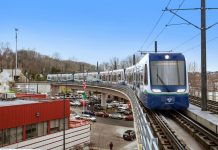 Sound Transit Speeds Up Delivery of 10 Link Cars to Handle Crowds A train makes the turn on elevated tracks near Mount Backer Station.