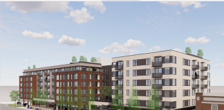 A six story apartment rendered with white siding on the corners and brick in the middle.