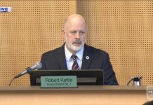 Seattle Police Contract Passes Despite Limited Accountability Measures, Budget Hit Kattle wears a blue suit and light gray beard and sits on Council dais.