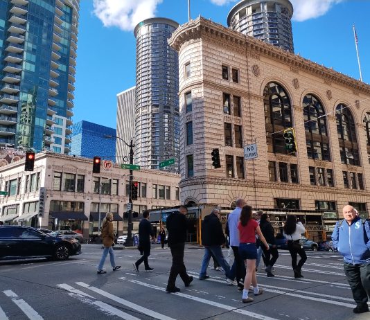 State Safety Plan Recommends Lower DUI Limit, Driver Education Reforms A crosswalk is filled with a dozen pedestrians in downtown Seattle.