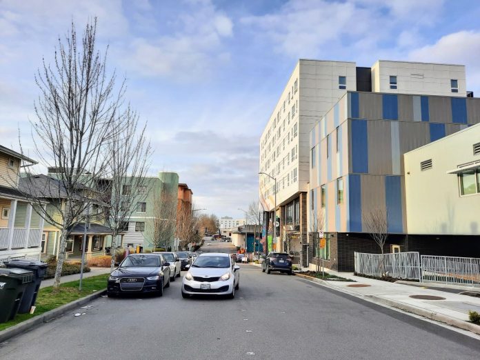 a new seven story apartment building and a side street