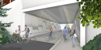 A rendering shows three people biking and three walking on the trail through the tunnel.