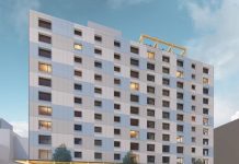 Affordable U District Tower Will Be Seattle’s Tallest Mass Timber Building A rendering shows a side profile with a light gray and blue facade and a simple but elegant window pattern.