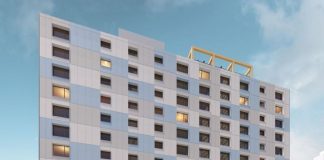 Affordable U District Tower Will Be Seattle’s Tallest Mass Timber Building A rendering shows a side profile with a light gray and blue facade and a simple but elegant window pattern.