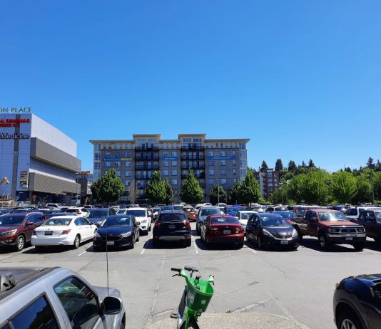 Parking Reform Gains Momentum at Washington Legislature A parking lot on a hot day in Northgate, with Thornton Place behind
