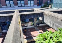 SLU Decision Points to Uphill Battle for Chinatown Station Advocates A view of the recessed Chinatown station platform from the surface, looking down through the concrete lattices overhead.