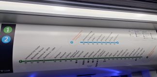 Above Link train doors are a simple map of stops with station names and numbers listed.