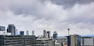 The Space Needle is visible in the distance between towers from a South Lake Union roofdeck.