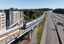 Join The Urbanist’s Lynnwood Link Opening Celebration at Hemlock State Brewing Elevated light rail tracks skirt Interstate 5 and a midrise residential building in Mountlake Terrace.