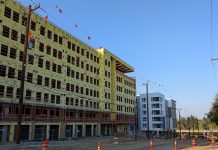 Ferguson Transition Team: Transit-Oriented Development Should Be ‘Top Priority’ An 8 story building under construction near a similarly sized building that is already completed.