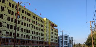 Ferguson Transition Team: Transit-Oriented Development Should Be ‘Top Priority’ An 8 story building under construction near a similarly sized building that is already completed.