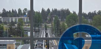 2 Line Beats Ridership Expectations, 1 Line Has Second-Best Month Ever A 2 icon decorates the mezzanine level overlooking the station platform with northern edge of downtown Bellevue in the background