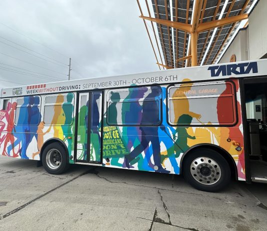 Week Without Driving Challenge Expands to 50 States from Seattle Launchpad The bus wrap ad shows silhouettes of people walking and rolling.