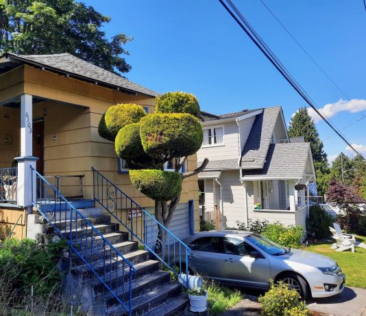 Op-Ed: Presidential Election Hinges on Housing, Conceptions of the American Dream Single family homes with cars in the driveway and trees in the background.