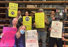 Harrell Proposes Deep Cuts for Tenant Assistance, Advocates Push Back Tenants hold signs saying "hold bad landlords accountable" and "everyone deserves dignified housing" and "SROC stands against abusive landlords" and "workers rights = renters' rights"