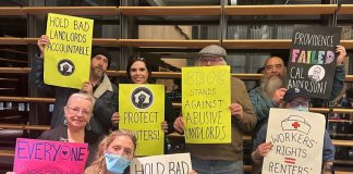 Harrell Proposes Deep Cuts for Tenant Assistance, Advocates Push Back Tenants hold signs saying "hold bad landlords accountable" and "everyone deserves dignified housing" and "SROC stands against abusive landlords" and "workers rights = renters' rights"