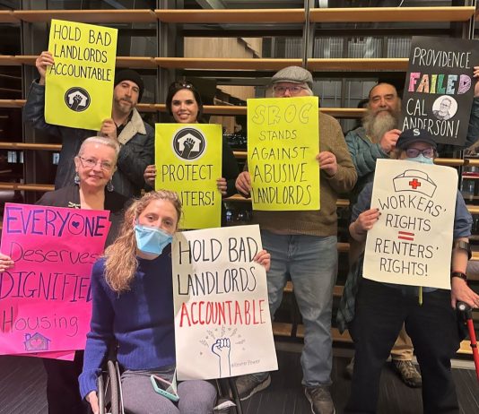 Op-Ed: Five Ways to Lower Rents in Seattle Tenants hold signs saying "hold bad landlords accountable" and "everyone deserves dignified housing" and "SROC stands against abusive landlords" and "workers rights = renters' rights"
