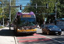 King County Metro Testing Onboard Cameras to Cite Bus-Lane Violators A Route 7 bus comes down Rainier Avenue on a sunny day in a red bus lane