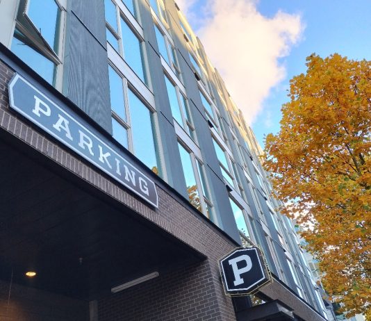 Bateman Takes Aim at Washington’s Parking Mandates A sign on an apartment building indicating the parking entrance